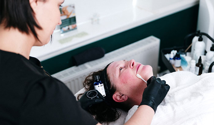 Woman receiving skin peel